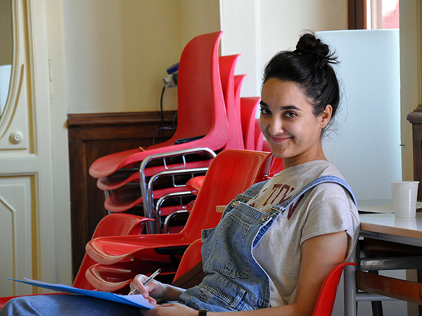 Portrait of a lady with red chairs