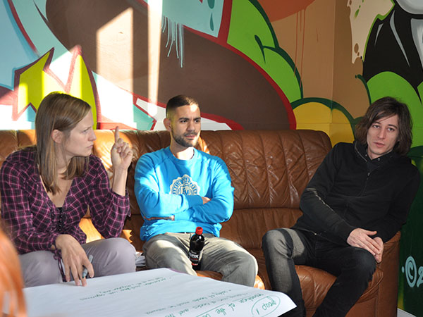 Anne, Nassim, and Michel on a sofa