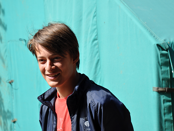 In front of a turquoise tent